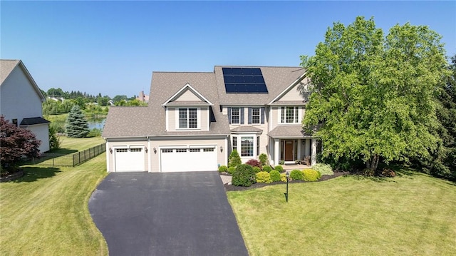 4 Crowne Pointe Dr, Penfield, NY 14526 - view of front of property featuring asphalt driveway, solar panels, and an attached garage