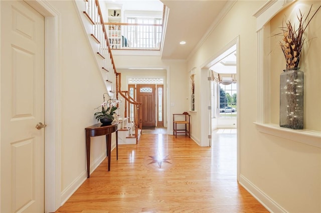 4 Crowne Pointe Dr, Penfield, NY 14526 - foyer entrance featuring stairs, light wood finished floors, and ornamental molding
