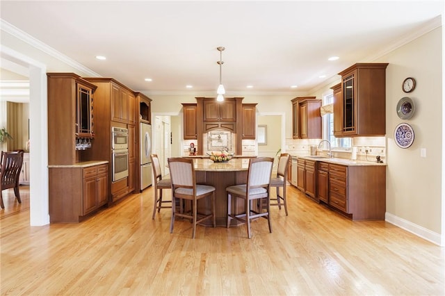 4 Crowne Pointe Dr, Penfield, NY 14526 - kitchen with appliances with stainless steel finishes, a kitchen island, a kitchen bar, glass insert cabinets, and light wood finished floors