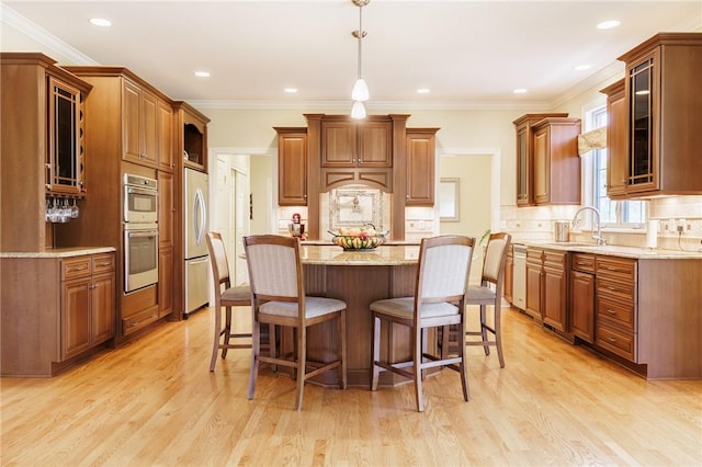 4 Crowne Pointe Dr, Penfield, NY 14526 - kitchen with freestanding refrigerator, a center island, stainless steel double oven, a breakfast bar, and recessed lighting