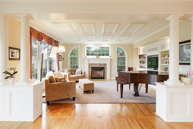 4 Crowne Pointe Dr, Penfield, NY 14526 - living room featuring ornate columns, light wood-style flooring, and a fireplace with flush hearth