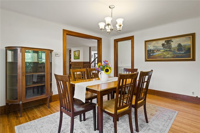 29 Stonehenge Rd, Irondequoit, NY 14609 - dining space featuring a chandelier, light wood-style floors, and crown molding