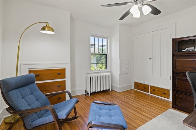 29 Stonehenge Rd, Irondequoit, NY 14609 - sitting room featuring radiator, a ceiling fan, and wood finished floors