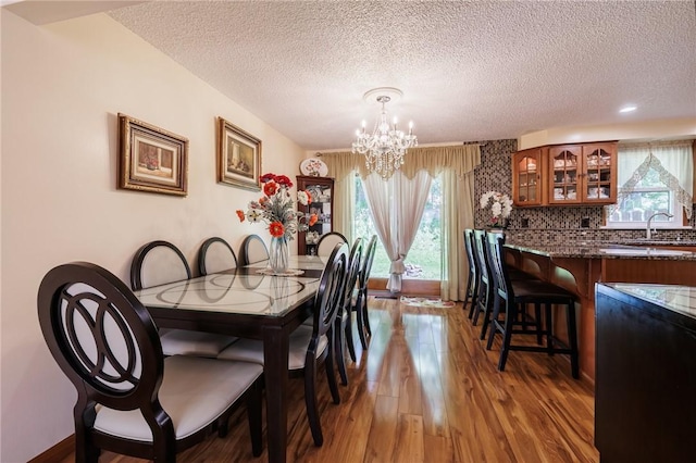 18 Chesterton Ct, Perinton, NY 14450 - dining room featuring a chandelier, a textured ceiling, plenty of natural light, and wood finished floors