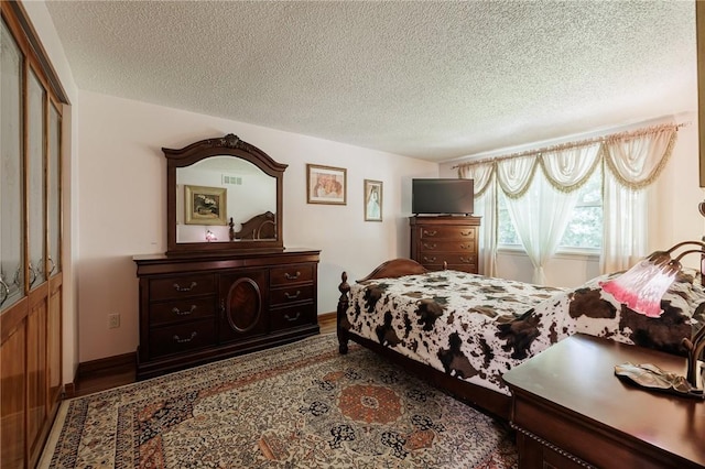 18 Chesterton Ct, Perinton, NY 14450 - bedroom featuring a textured ceiling and wood finished floors