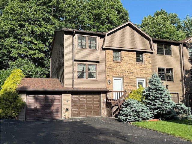 18 Chesterton Ct, Perinton, NY 14450 - view of front of property with asphalt driveway, brick siding, and a garage