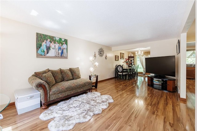 18 Chesterton Ct, Perinton, NY 14450 - living area featuring a chandelier and wood finished floors