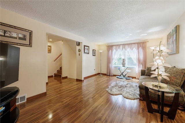 18 Chesterton Ct, Perinton, NY 14450 - living room featuring a textured ceiling, stairway, and wood finished floors