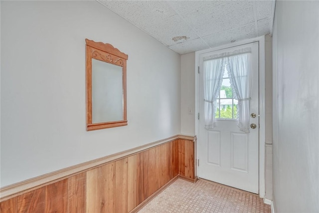 53 Eileen Dr, Greece, NY 14616 - entryway with a wainscoted wall, light tile patterned flooring, and wood walls