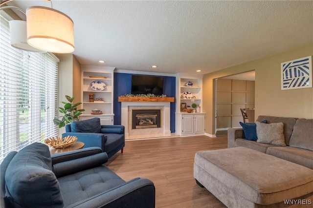 278 Shady Grove Dr, Amherst, NY 14051 - living room with a textured ceiling, wood finished floors, a high end fireplace, and recessed lighting