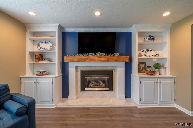 278 Shady Grove Dr, Amherst, NY 14051 - living area with built in shelves, wood finished floors, a high end fireplace, a textured ceiling, and recessed lighting