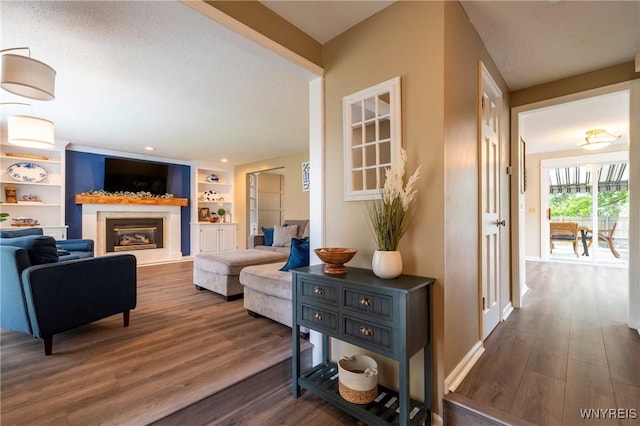 278 Shady Grove Dr, Amherst, NY 14051 - living room featuring dark wood finished floors, a glass covered fireplace, and built in features