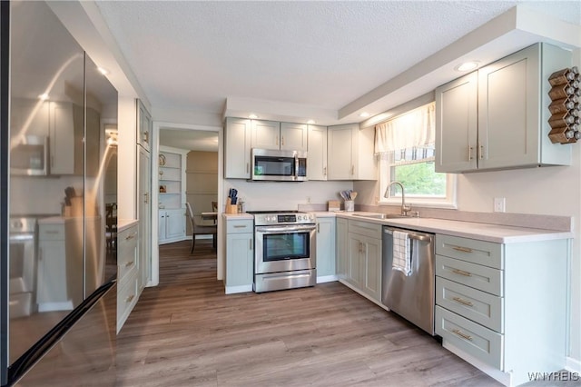 278 Shady Grove Dr, Amherst, NY 14051 - kitchen featuring appliances with stainless steel finishes, light wood-type flooring, light countertops, recessed lighting, and a textured ceiling