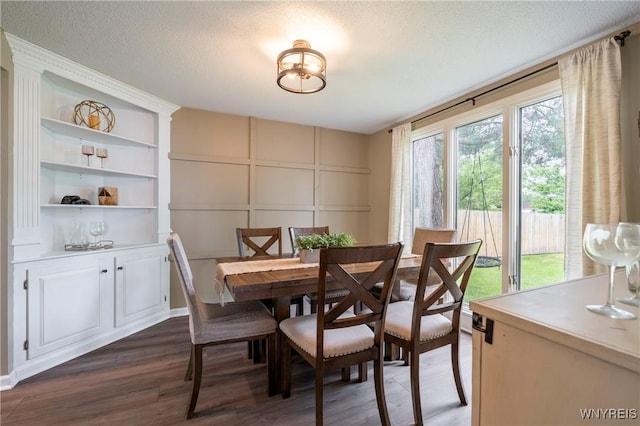 278 Shady Grove Dr, Amherst, NY 14051 - dining room with a decorative wall, dark wood-style flooring, built in features, and a textured ceiling