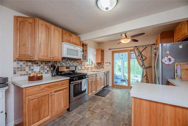 229 Angelus Dr, Irondequoit, NY 14622 - kitchen featuring stainless steel appliances, backsplash, ceiling fan, glass insert cabinets, and light countertops