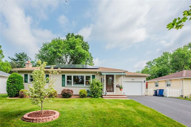 229 Angelus Dr, Irondequoit, NY 14622 - single story home with a garage, asphalt driveway, solar panels, and a chimney