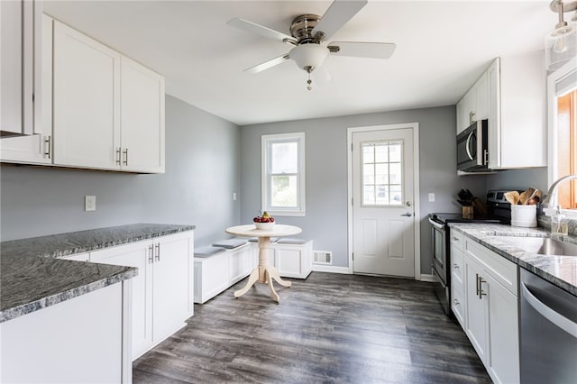 196 Saint Johns Dr, Greece, NY 14626 - kitchen with stainless steel appliances, white cabinets, a ceiling fan, and dark wood finished floors