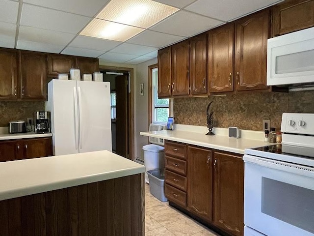 22869AND22871 State Highway 23, Harpersfield, NY 13786 - kitchen with white appliances, light countertops, backsplash, dark brown cabinetry, and light tile patterned floors