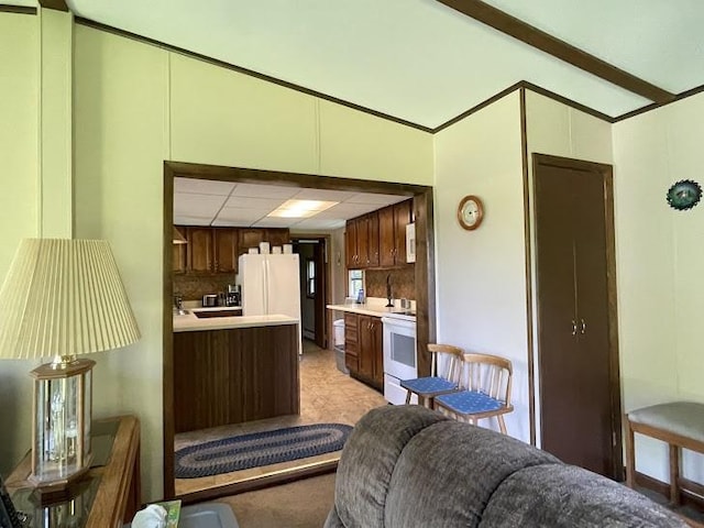 22869AND22871 State Highway 23, Harpersfield, NY 13786 - kitchen with white appliances, light countertops, vaulted ceiling, a peninsula, and dark brown cabinets