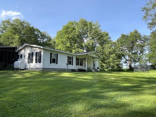 22869AND22871 State Highway 23, Harpersfield, NY 13786 - view of front facade with a trampoline, a front lawn, heating fuel, and crawl space