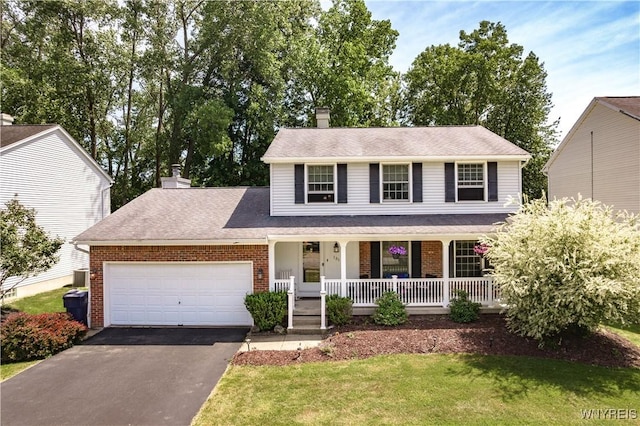 131 Daven Dr, Amherst, NY 14068 - view of front of property featuring brick siding, covered porch, driveway, an attached garage, and a chimney
