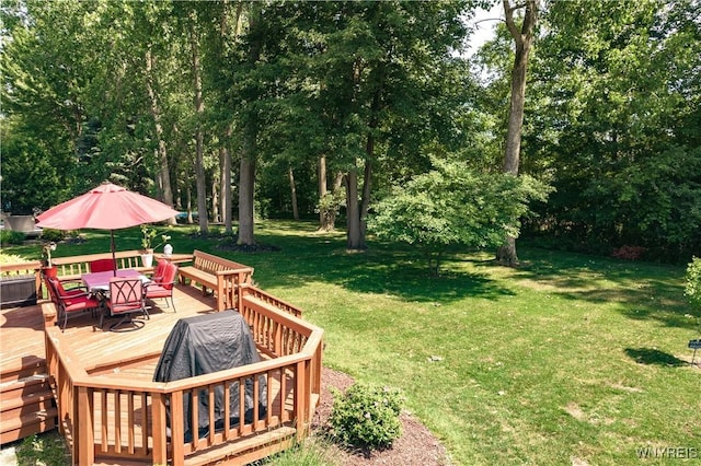 131 Daven Dr, Amherst, NY 14068 - view of grassy yard featuring outdoor dining space, a wooden deck, and view of wooded area
