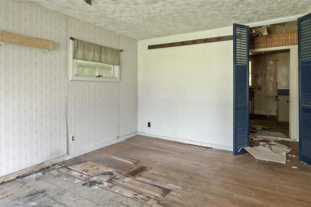 2429 English Rd, Greece, NY 14616 - spare room featuring wood finished floors and a textured ceiling