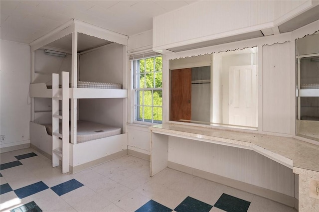 2429 English Rd, Greece, NY 14616 - unfurnished bedroom with tile patterned floors and baseboards