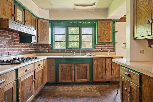 2429 English Rd, Greece, NY 14616 - kitchen with stainless steel gas cooktop, a paneled ceiling, light countertops, and brick patterned flooring