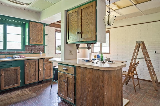 2429 English Rd, Greece, NY 14616 - kitchen with brick wall, brick patterned flooring, light countertops, decorative light fixtures, and a drop ceiling