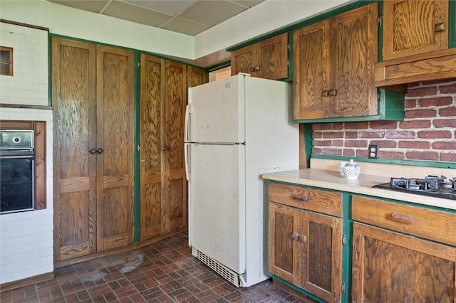 2429 English Rd, Greece, NY 14616 - kitchen with black appliances, brick patterned floors, light countertops, and brown cabinets