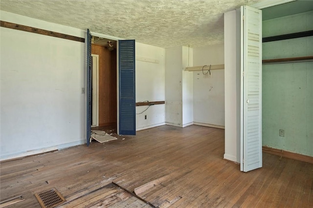 2429 English Rd, Greece, NY 14616 - unfurnished bedroom with wood-type flooring and a textured ceiling