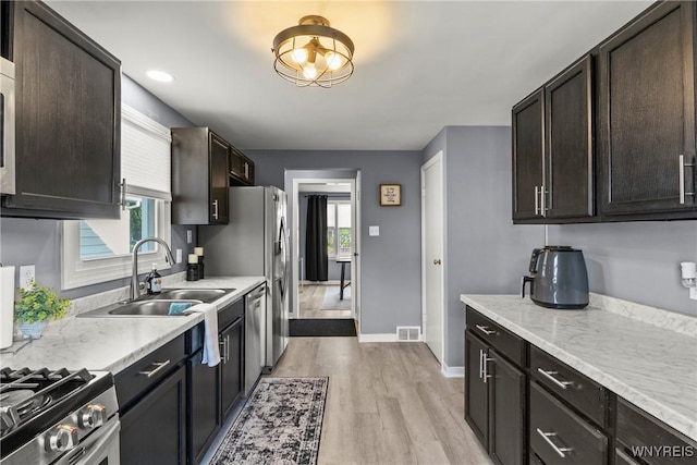 47 Waverly Ave, Tonawanda, NY 14217 - kitchen featuring light countertops, light wood-style flooring, healthy amount of natural light, and dark brown cabinets
