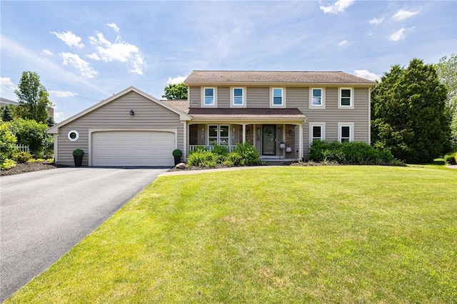 346 Willowood Dr, Greece, NY 14612 - colonial-style house with asphalt driveway, a porch, an attached garage, and a front yard
