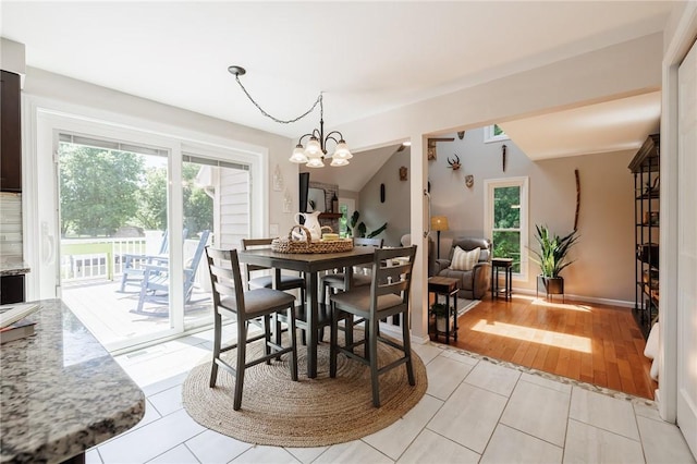346 Willowood Dr, Greece, NY 14612 - dining area with a chandelier and light tile patterned flooring