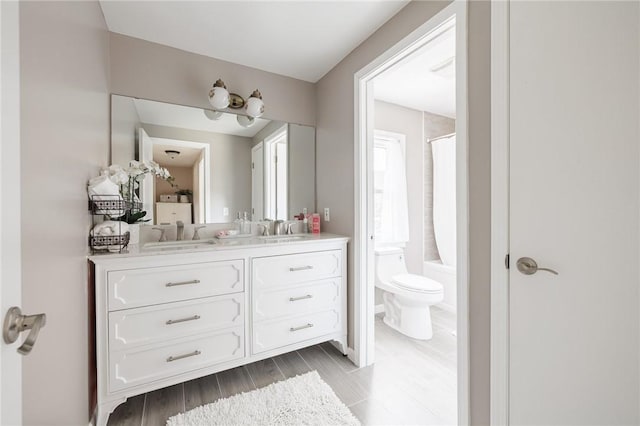 346 Willowood Dr, Greece, NY 14612 - full bathroom featuring double vanity, shower / bathtub combination with curtain, and wood finished floors