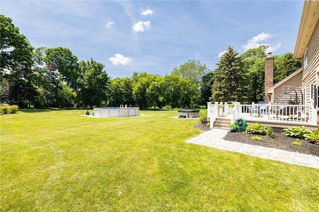 346 Willowood Dr, Greece, NY 14612 - view of green lawn featuring a deck, view of scattered trees, and an outdoor pool