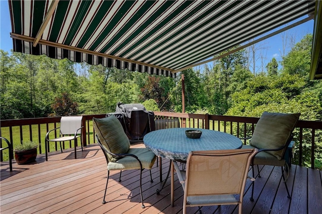 1622 Magog Rd, Macedon, NY 14502 - wooden deck with outdoor dining area, area for grilling, and a wooded view
