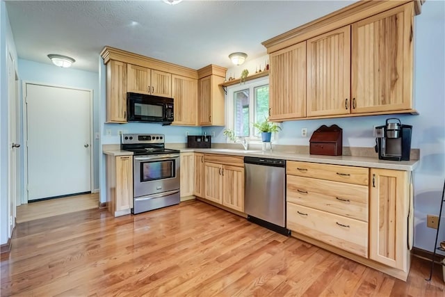 1622 Magog Rd, Macedon, NY 14502 - kitchen with appliances with stainless steel finishes, light brown cabinets, light wood finished floors, and light countertops