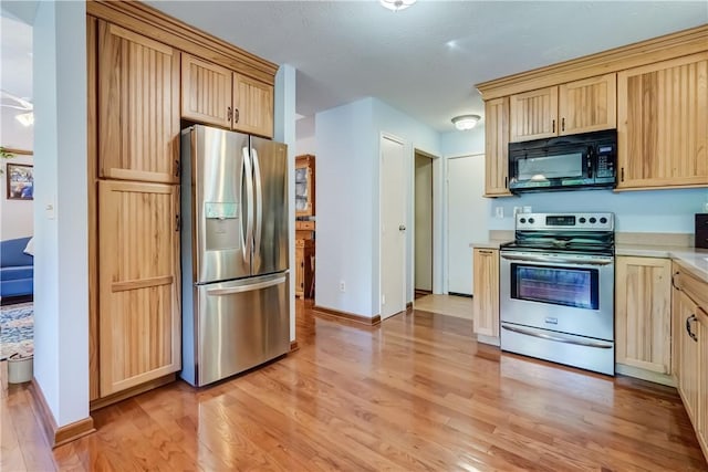 1622 Magog Rd, Macedon, NY 14502 - kitchen with appliances with stainless steel finishes, light wood-style floors, light brown cabinets, and light countertops