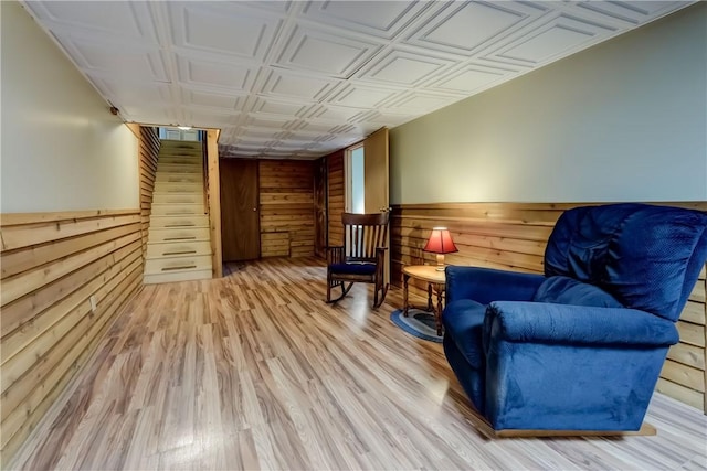 1622 Magog Rd, Macedon, NY 14502 - living area featuring wooden walls, stairs, an ornate ceiling, wood finished floors, and a wainscoted wall