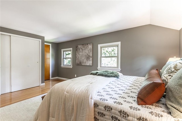 125 Amsterdam Rd, Rochester, NY 14610 - bedroom with light wood-style flooring, a closet, and vaulted ceiling