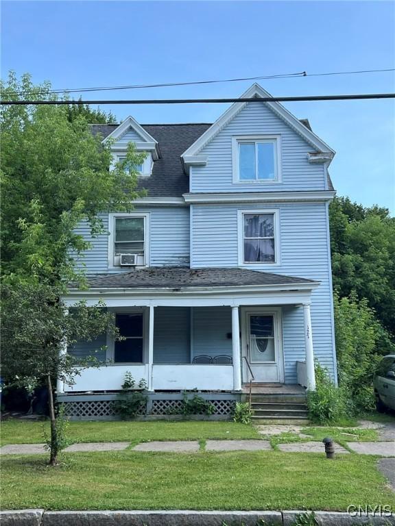 127 W Ostrander Ave, Syracuse, NY 13205 - view of front of home featuring a front yard, a porch, roof with shingles, and cooling unit