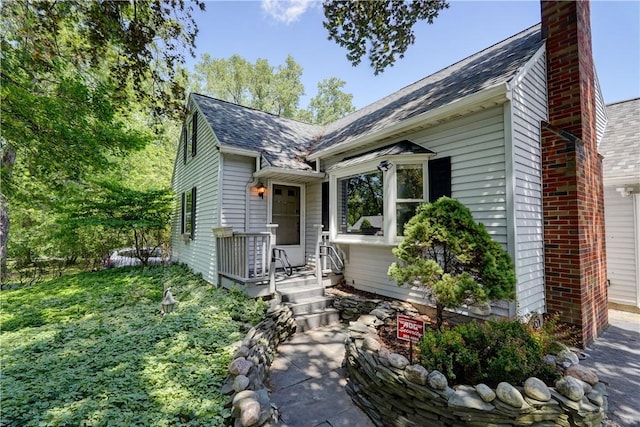36 Oakmount Dr, Irondequoit, NY 14617 - view of front of home with a chimney and a shingled roof