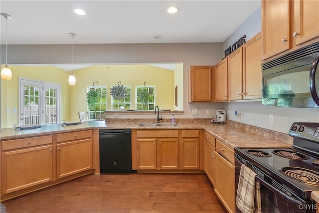 117 Shaker Hts, Camillus, NY 13031 - kitchen with black appliances, wood finished floors, recessed lighting, hanging light fixtures, and light countertops