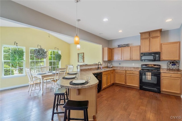 117 Shaker Hts, Camillus, NY 13031 - kitchen featuring black appliances, a peninsula, dark wood-style flooring, light brown cabinetry, and a breakfast bar area