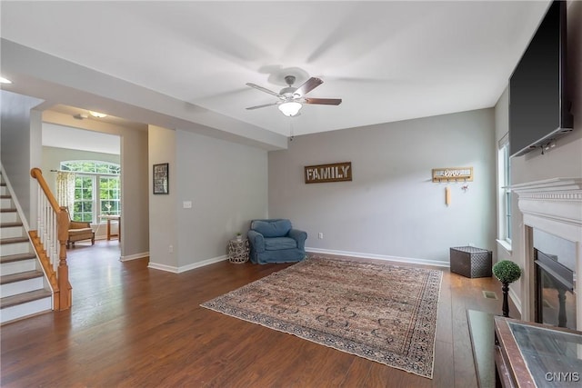 117 Shaker Hts, Camillus, NY 13031 - sitting room featuring ceiling fan, wood finished floors, a glass covered fireplace, and stairway