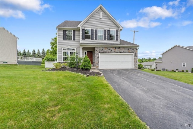 117 Shaker Hts, Camillus, NY 13031 - view of front of house featuring a garage, asphalt driveway, stone siding, and a front yard