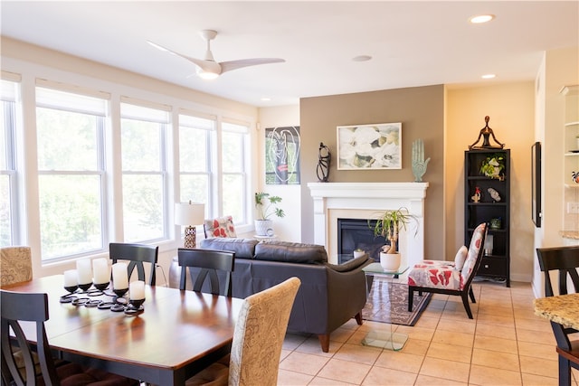 84 Watersong, Penfield, NY 14580 - dining room featuring a glass covered fireplace, light tile patterned flooring, ceiling fan, and recessed lighting