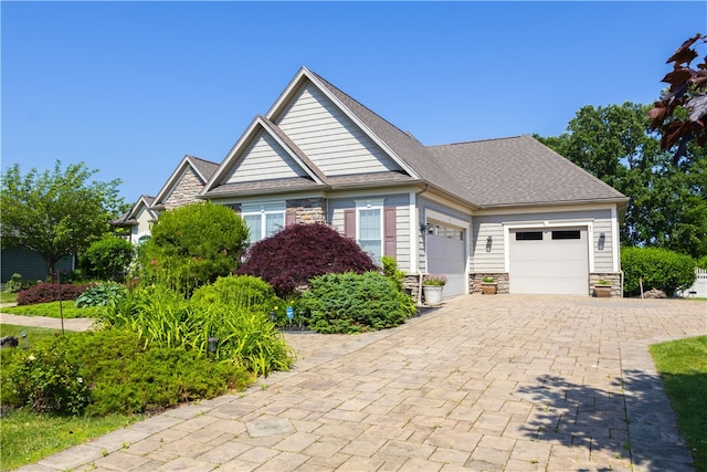 84 Watersong, Penfield, NY 14580 - craftsman inspired home with stone siding, a garage, decorative driveway, and a shingled roof